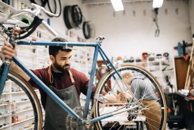 Mechanic working on a bicycle inside the Spoke & Line workshop