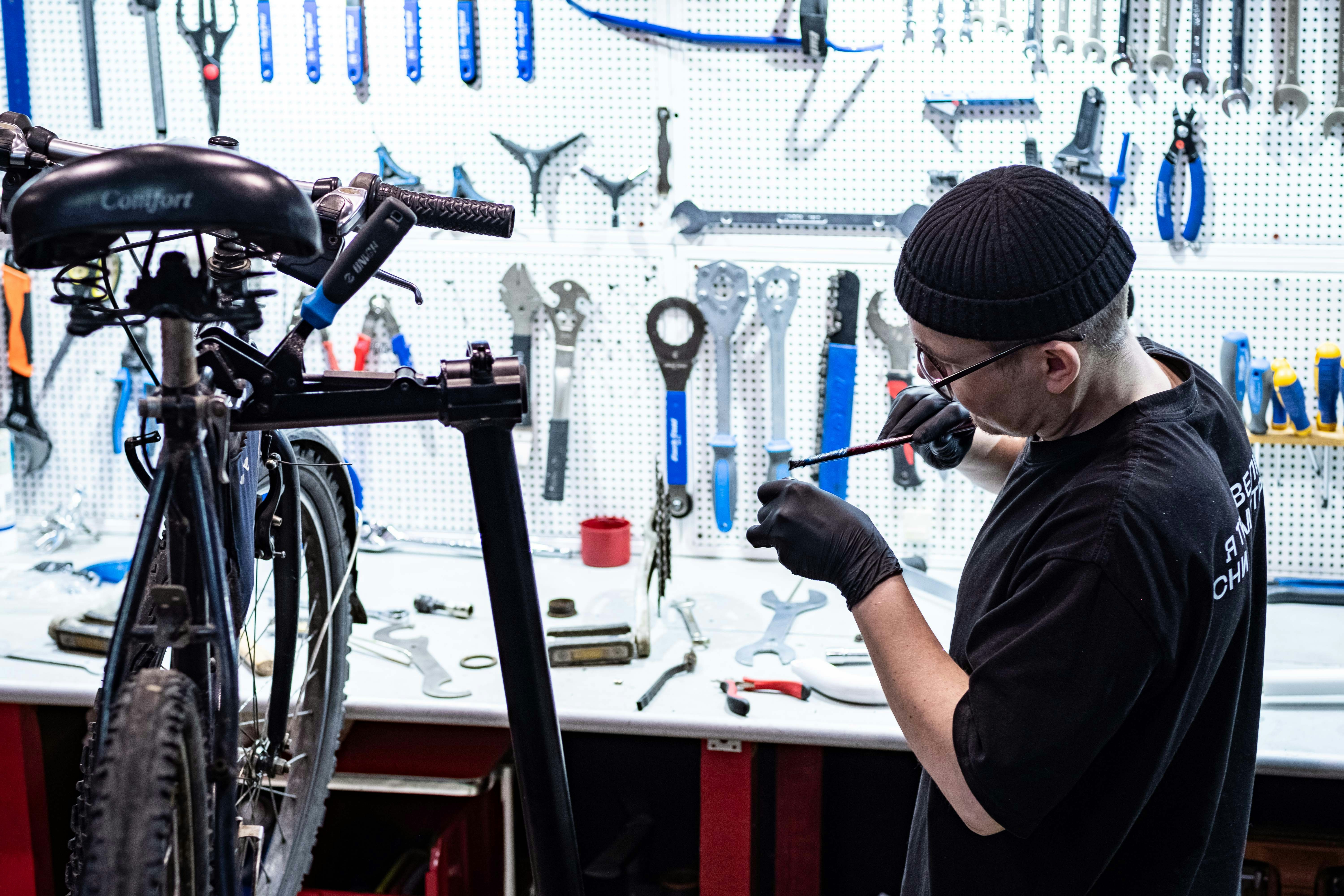 Close-up of a mechanic working on a custom bicycle frame